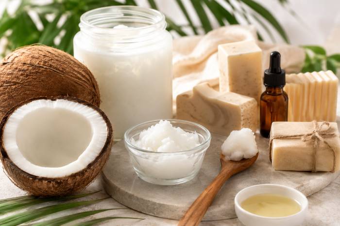 Craft oil next to coconut and bars of soap
