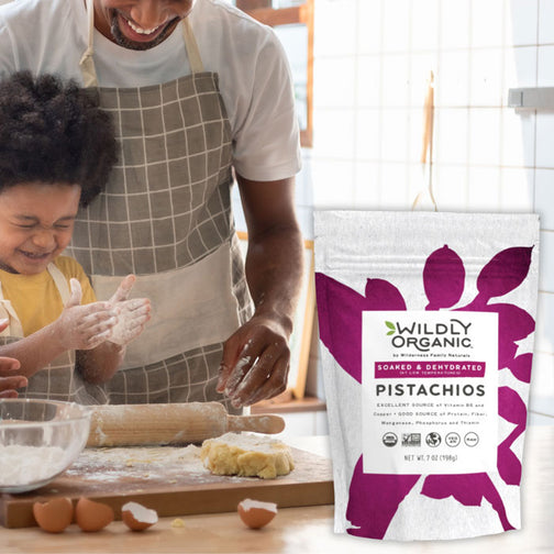 Father and son cooking with organic raw pistachio nuts