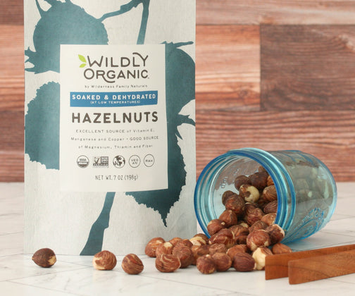 Hazelnuts beside packaging